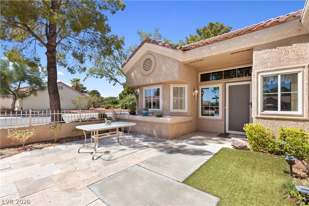 Tiled flooring and sturdy stucco walls frame this sunny entry courtyard.