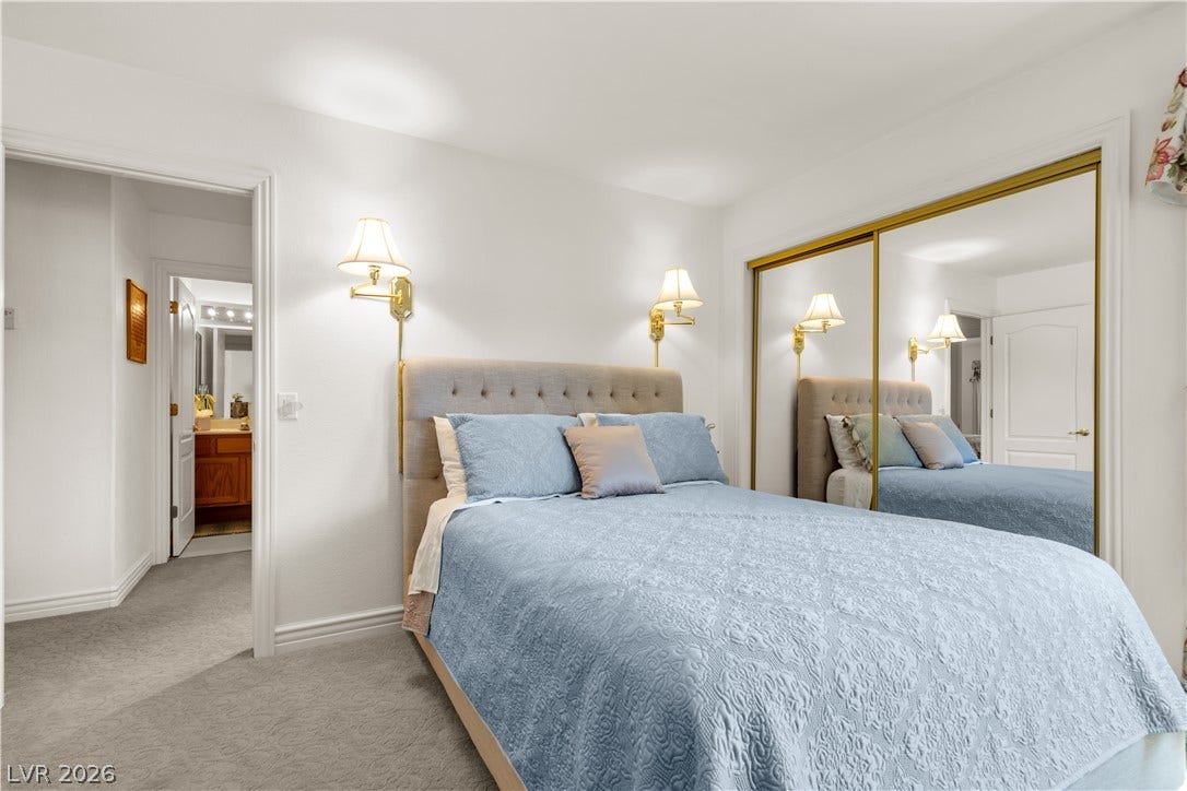Plush carpeting and mirrored closet doors enhance this cozy sleeping space with ensuite access.