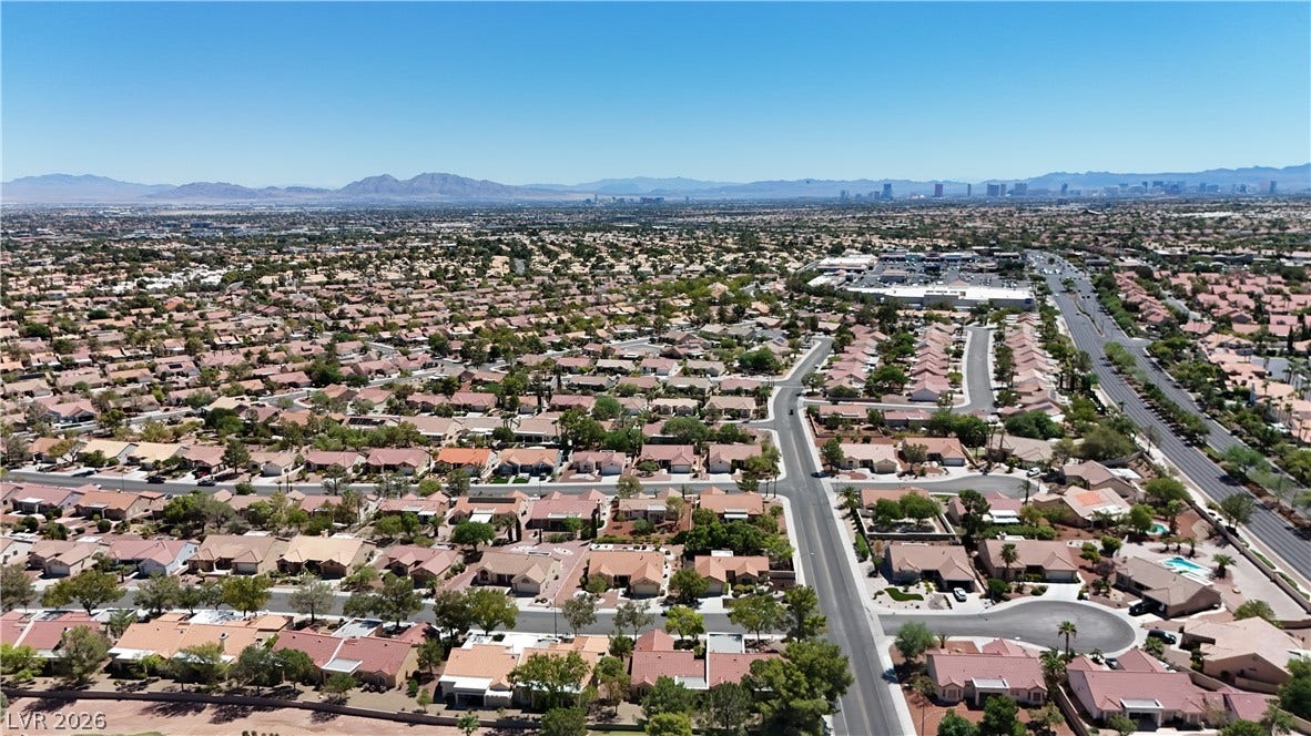 Scenic neighborhood panoramas showcase a sprawling residential valley bordered by distant mountains.