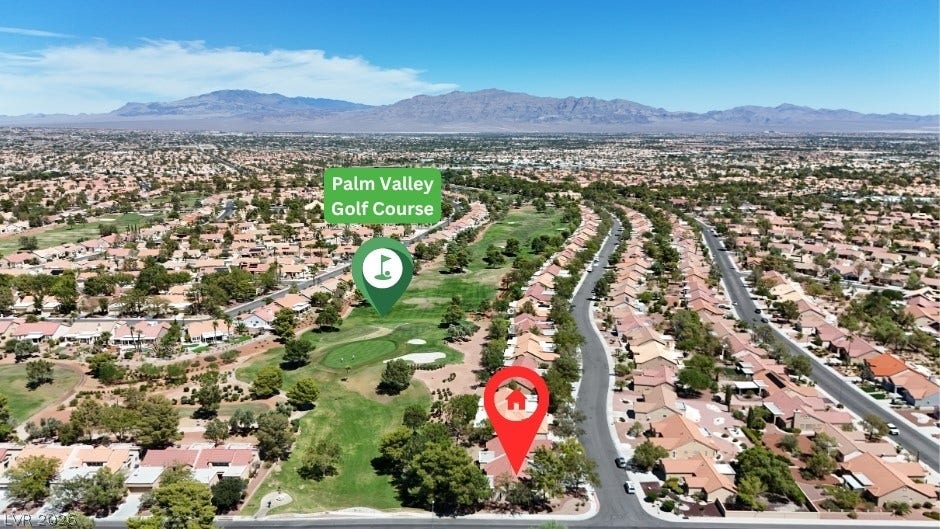 An aerial perspective captures the neighborhood setting adjacent to the golf course and distant mountains.