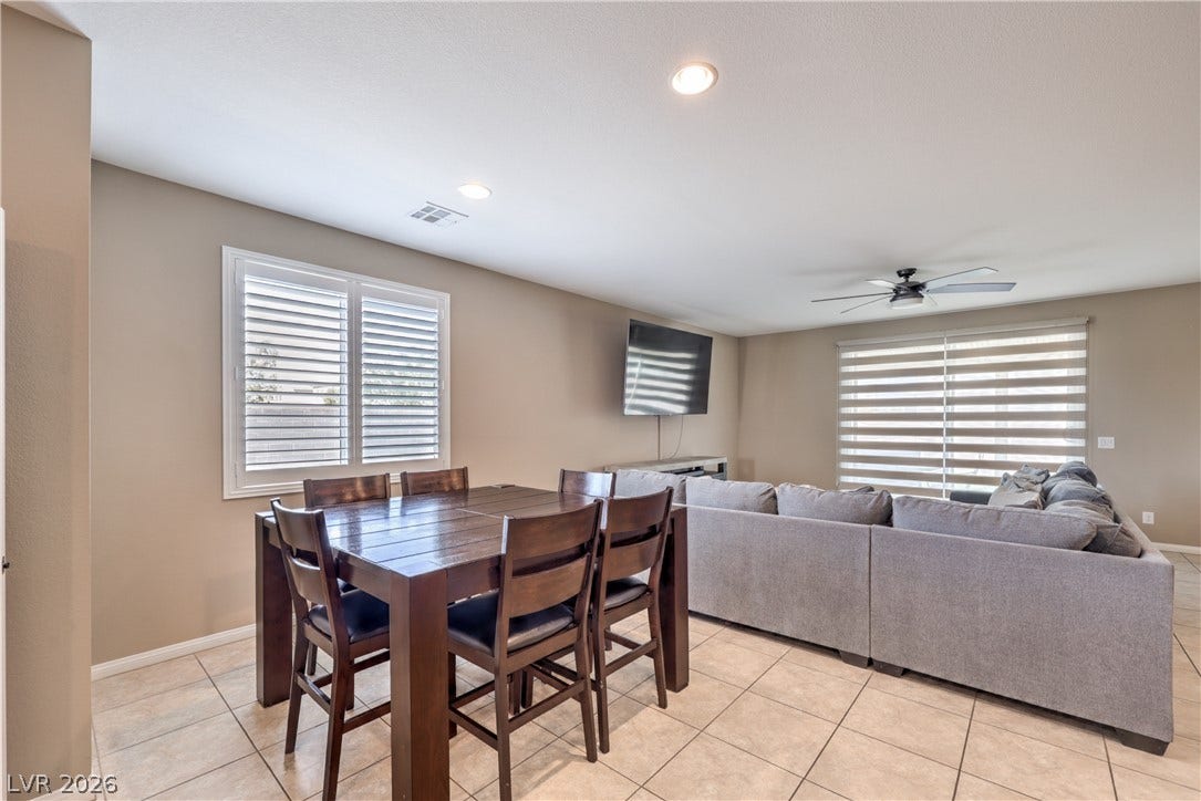 4658 Chestnut Tiger Street, North Las Vegas, NV 89031 An open living space transitions into a dining area accented by neutral tiled floors.
