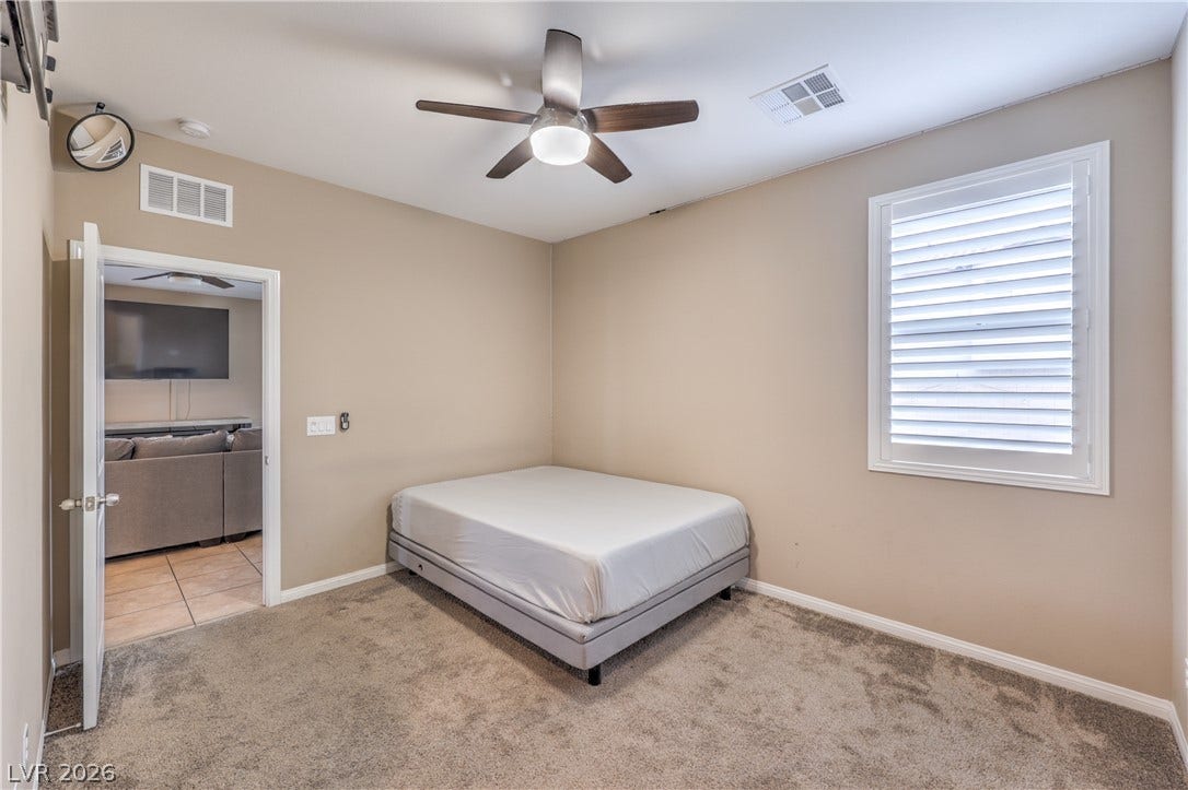 4658 Chestnut Tiger Street, North Las Vegas, NV 89031 Plush carpeting and plantation shutters define this cozy secondary bedroom.