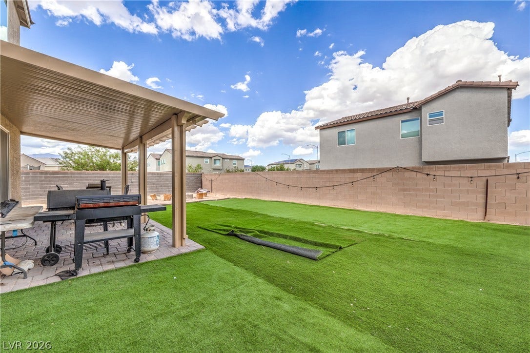 4658 Chestnut Tiger Street, North Las Vegas, NV 89031 A spacious backyard features a covered patio and a fully enclosed wall boundary.