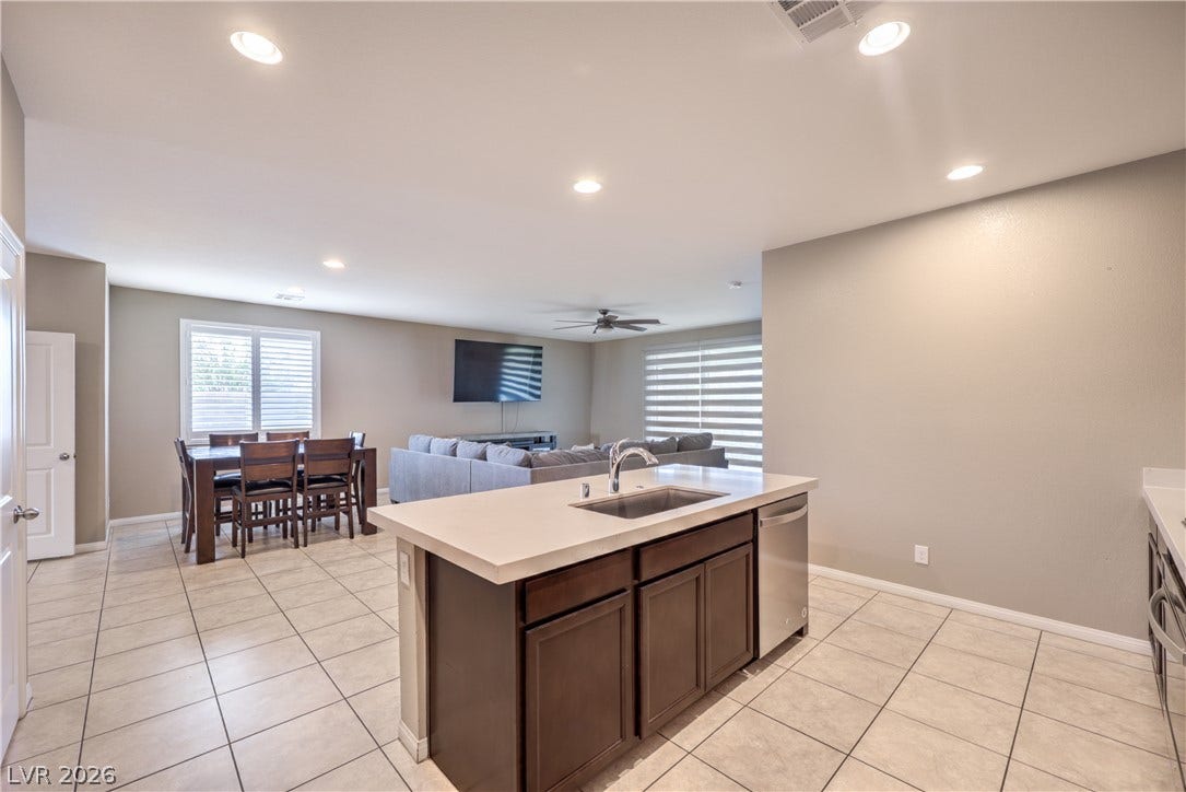 4658 Chestnut Tiger Street, North Las Vegas, NV 89031 An open floor plan connects the kitchen island to the dining and living spaces.
