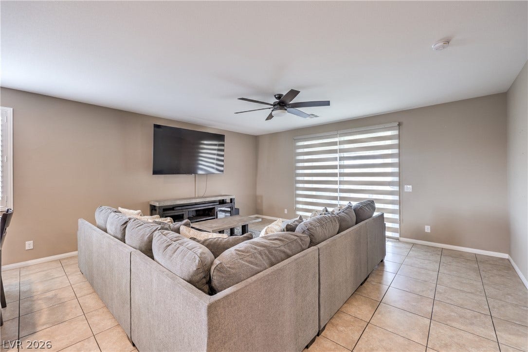 4658 Chestnut Tiger Street, North Las Vegas, NV 89031 Tiled flooring and broad sliding glass doors define this comfortable central living space.