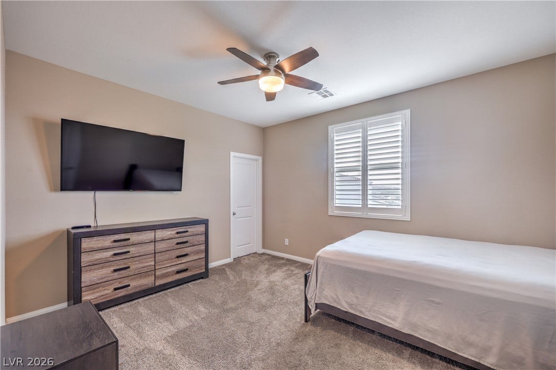 4658 Chestnut Tiger Street, North Las Vegas, NV 89031 Plush carpet underfoot and classic plantation shutters enhance this comfortable bedroom layout.