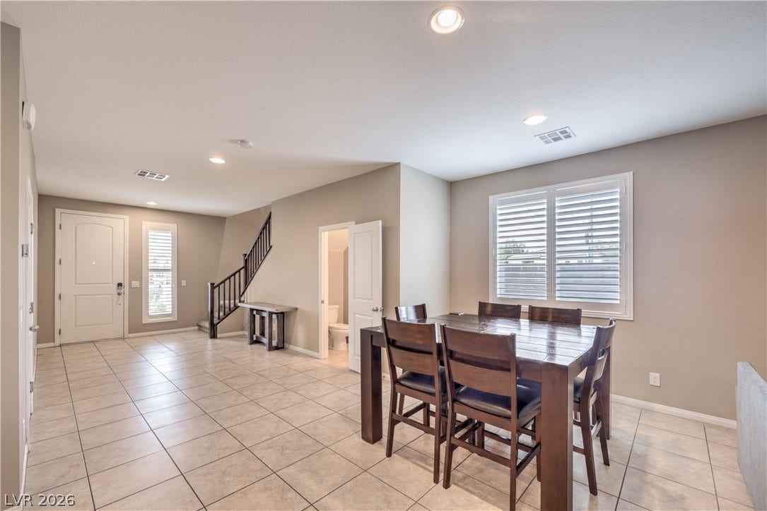 4658 Chestnut Tiger Street, North Las Vegas, NV 89031 Tiled flooring and recessed lighting define this versatile dining area near the entryway and stairs.