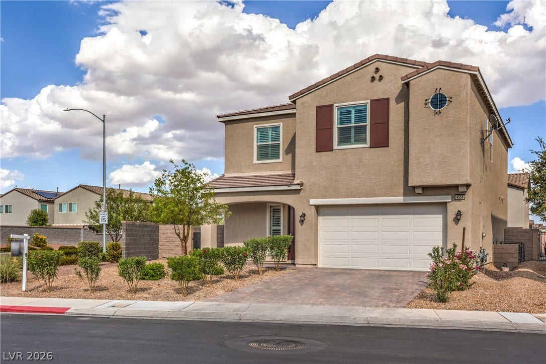 4658 Chestnut Tiger Street, North Las Vegas, NV 89031 A paved driveway leads to the integrated two-car garage of this modern stucco home.