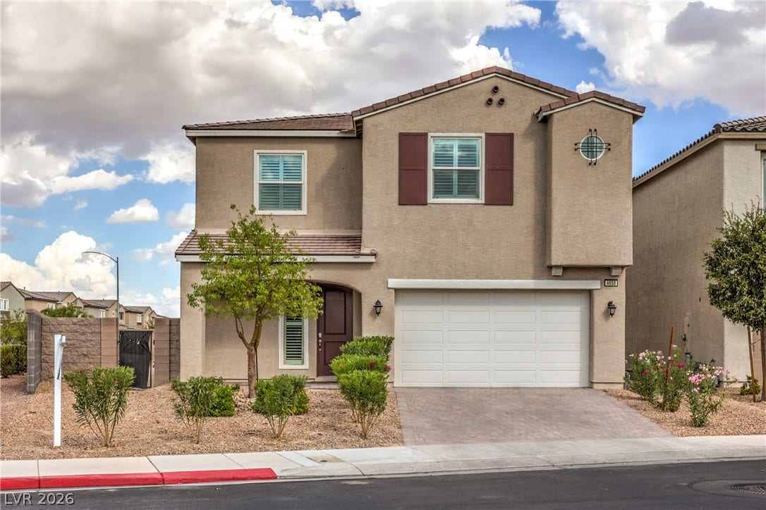4658 Chestnut Tiger Street, North Las Vegas, NV 89031 Stucco exterior siding, tile roof, and paved driveway define this contemporary two-story home.