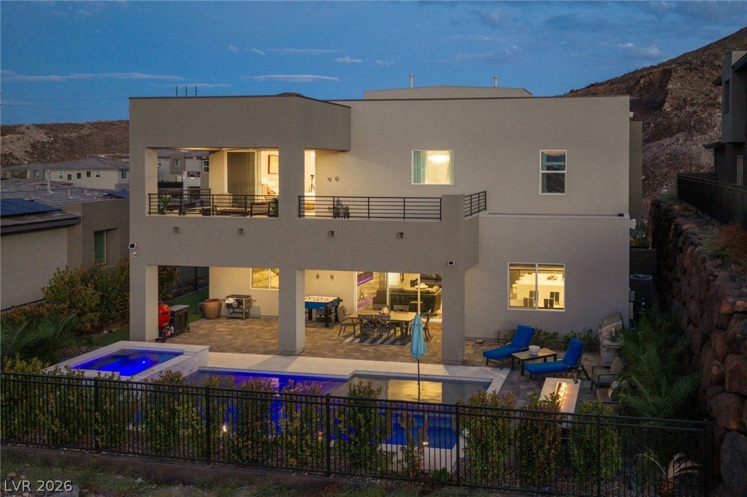 A modern multi-level residence features an integrated swimming pool and spacious covered patios.