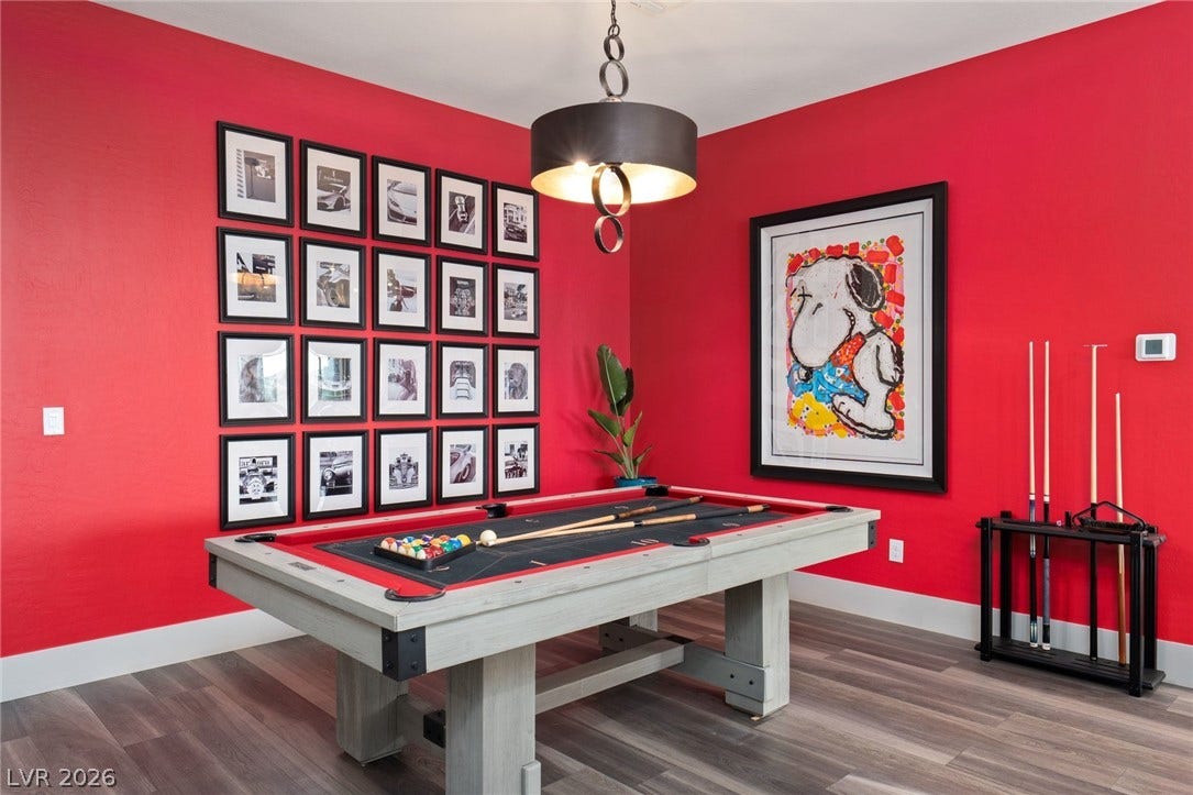 Smooth wood floors anchor this vibrant space designed for indoor recreation and entertainment.