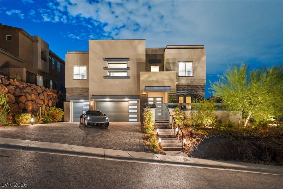 Bold contemporary architecture defines this multi-level exterior framed by desert landscaping and custom lighting.
