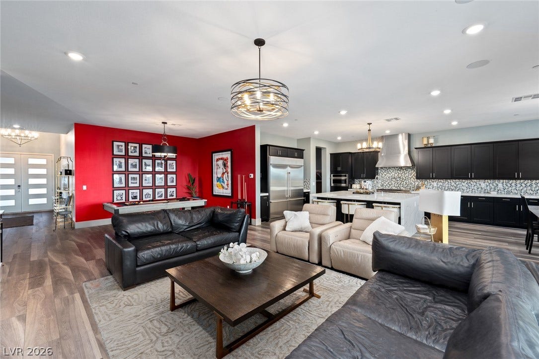 Recessed lighting and warm wood floors anchor this expansive open-concept main level.