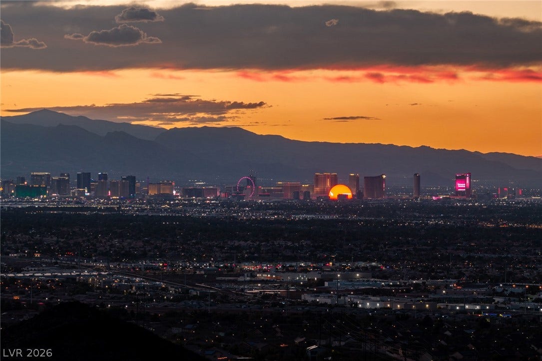 Dramatic sunset skies frame views of the distant city lights and mountain ridges.