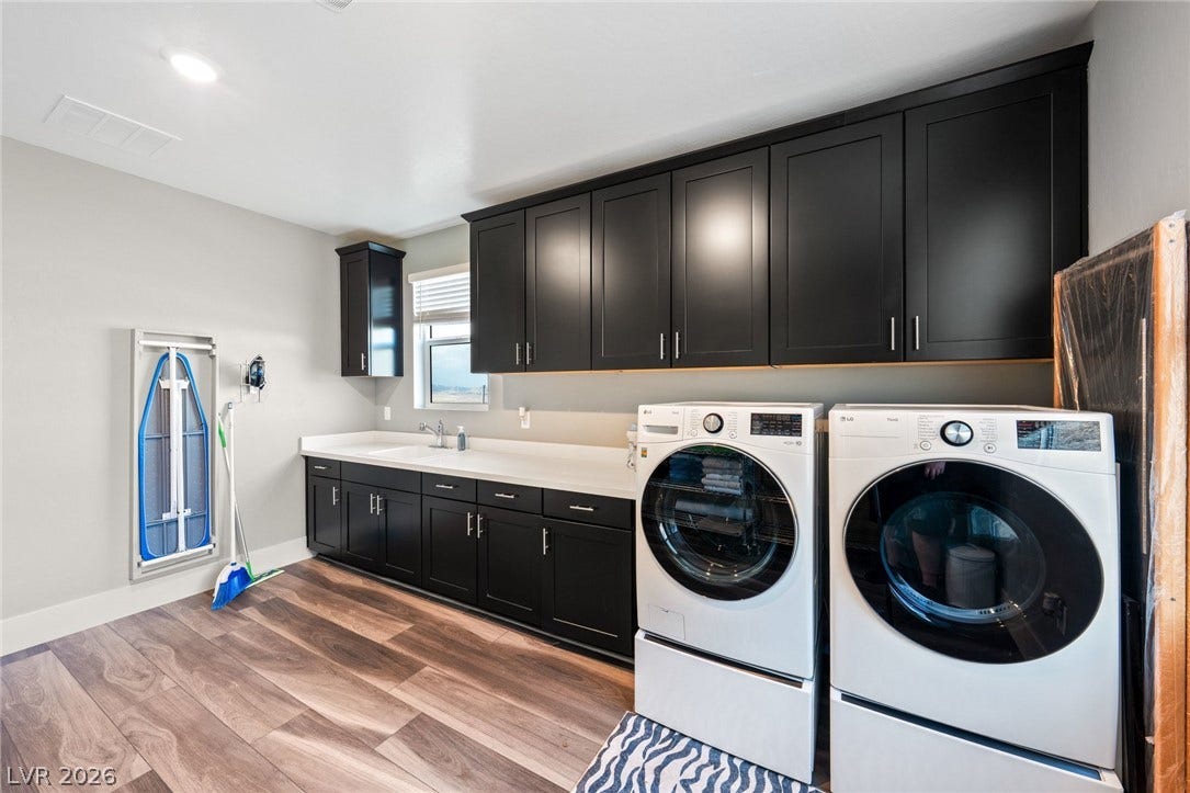 Rich dark cabinetry and handsome wood-patterned flooring define this highly functional workspace.