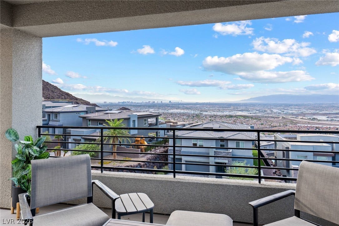 Panoramic mountain and valley vistas stretch across the horizon from this covered concrete balcony.