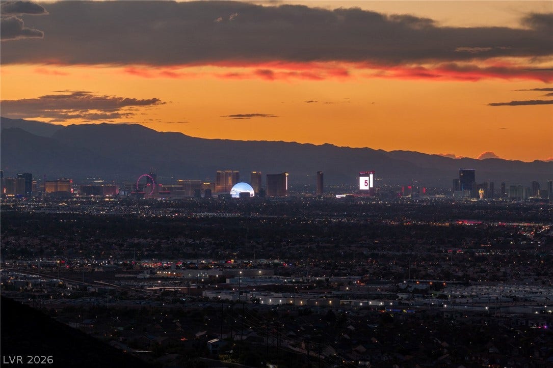 Panoramic mountain and skyline vistas create a dramatic backdrop at twilight.