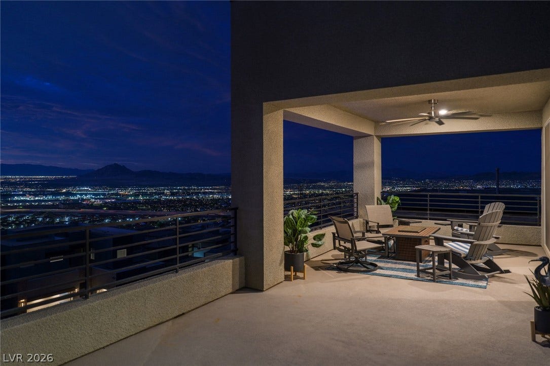 Glittering city lights unfold from a spacious covered terrace designed for evening relaxation.