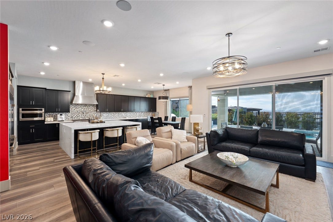 Gleaming wood floors flow through this airy open design connecting kitchen and living spaces.