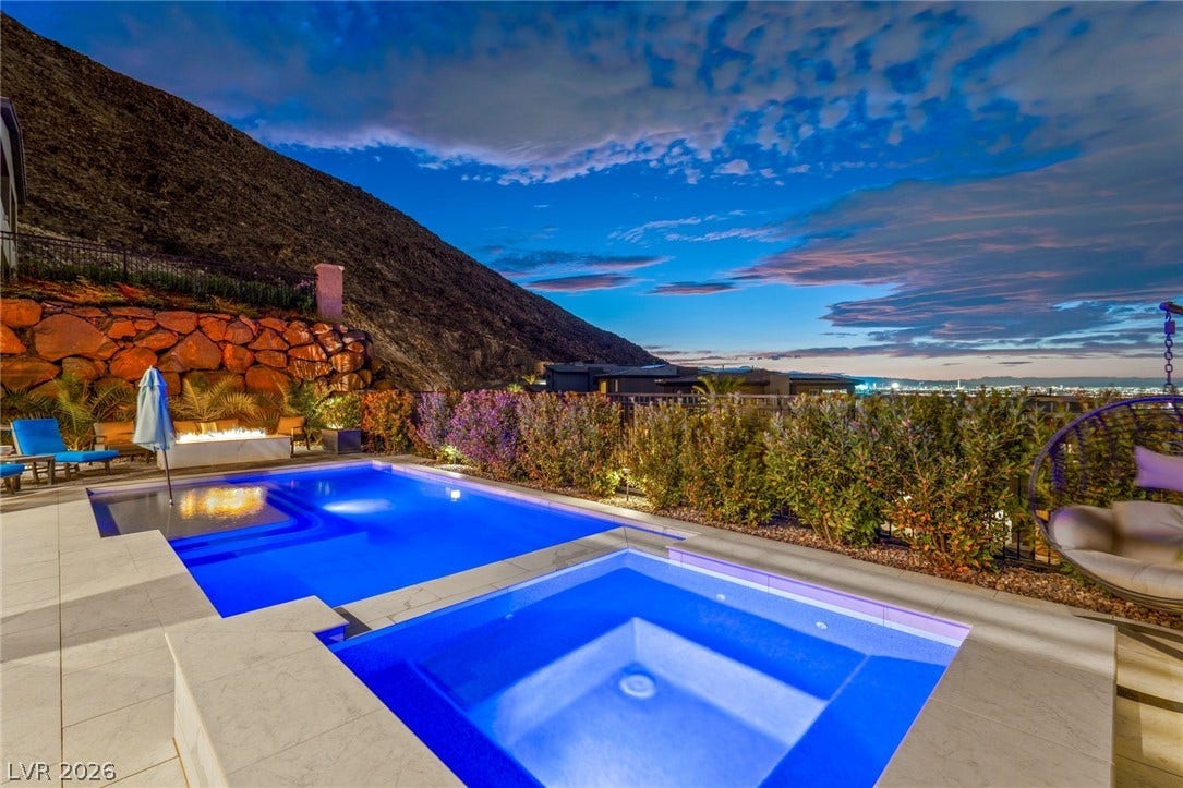 Dramatic mountain vistas frame this luminous outdoor pool and integrated spa terrace.