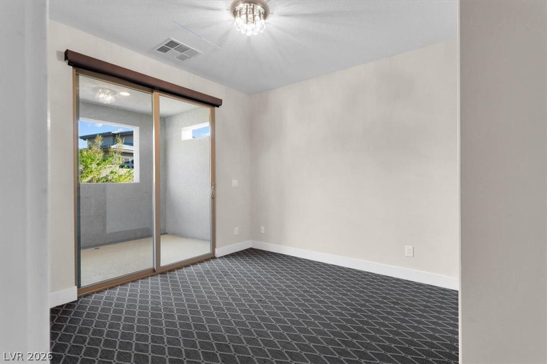 Second floor bedroom with attached bath, custom closets, and private balcony