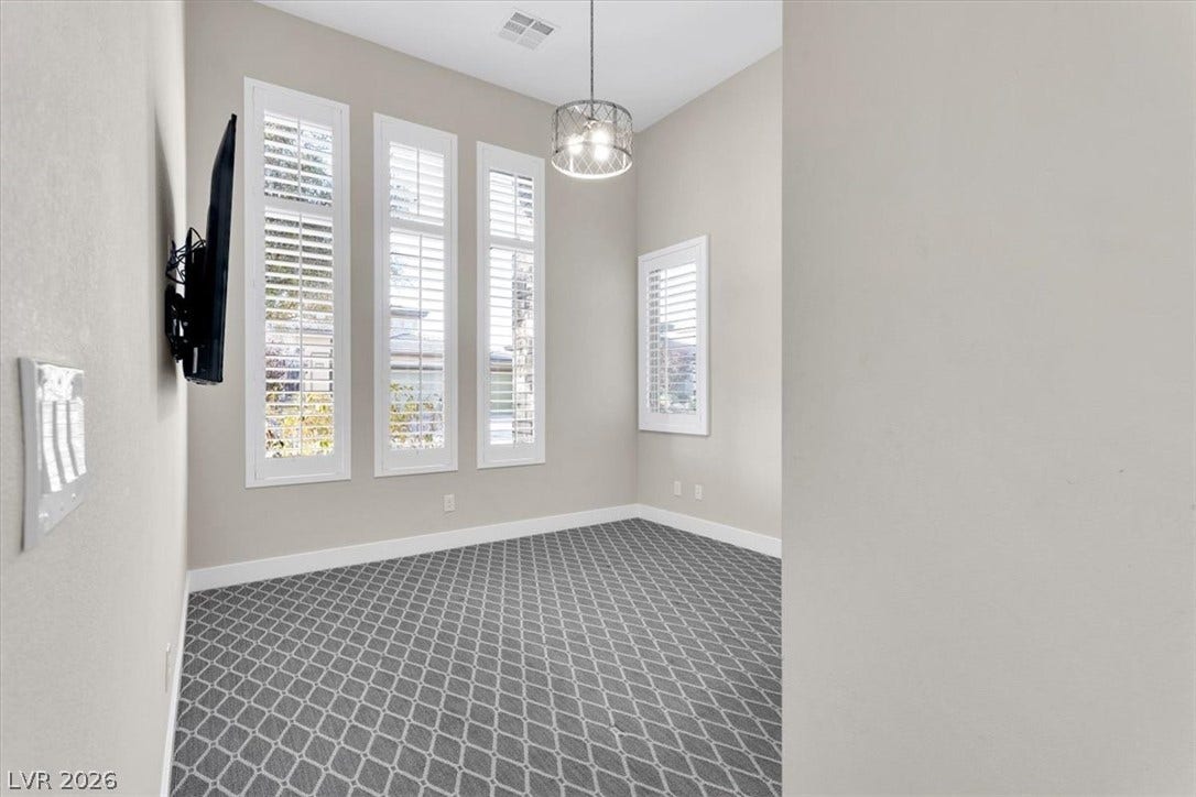 Downstairs bedroom featuring custom lights, plush carpet, and custom closet