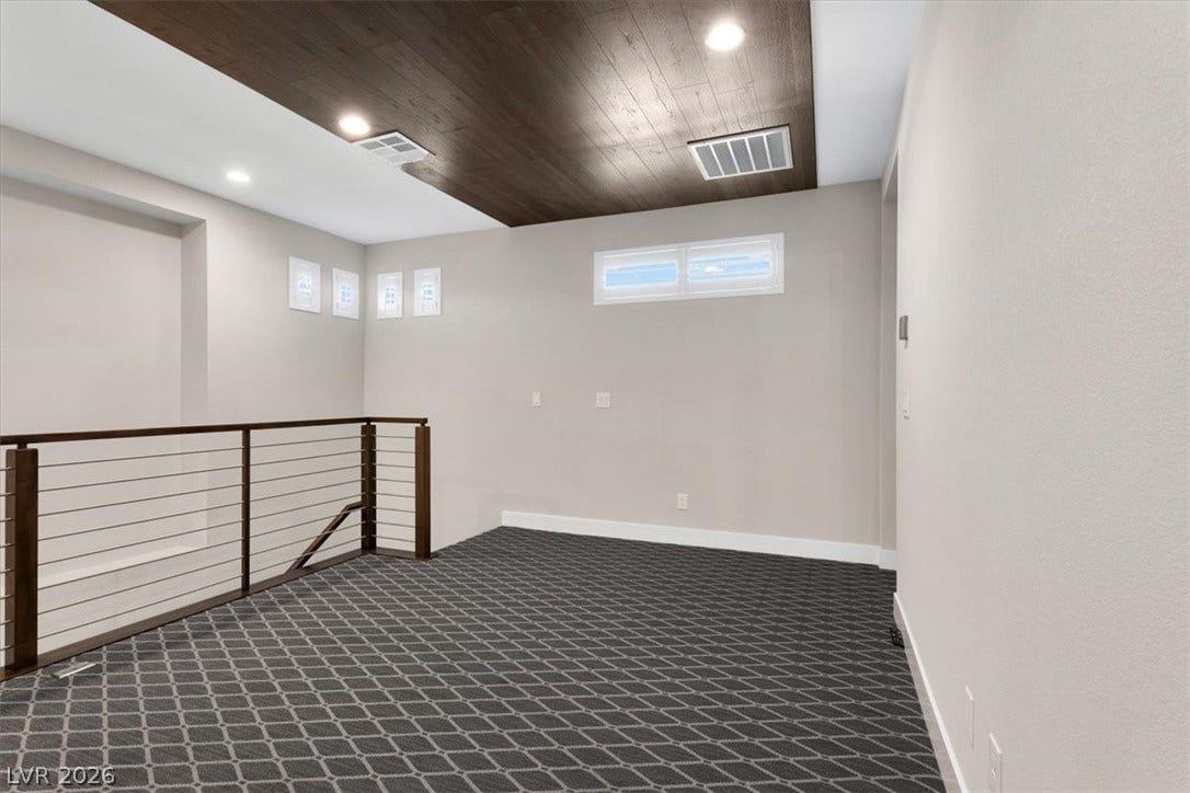 Second floor loft perfect for movie nights featuring plush carpet, recessed lighting, and wooden ceiling accents. Alongside the forth bedroom and bathroom