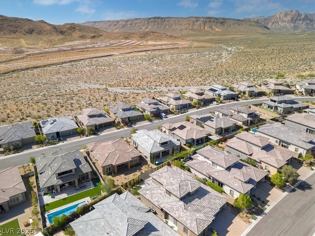 Aerial perspective of suburban area featuring a Red Rock mountain backdrop