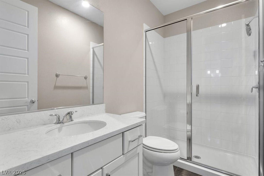 Second floor bedroom with attached bath, custom closets, and private balcony