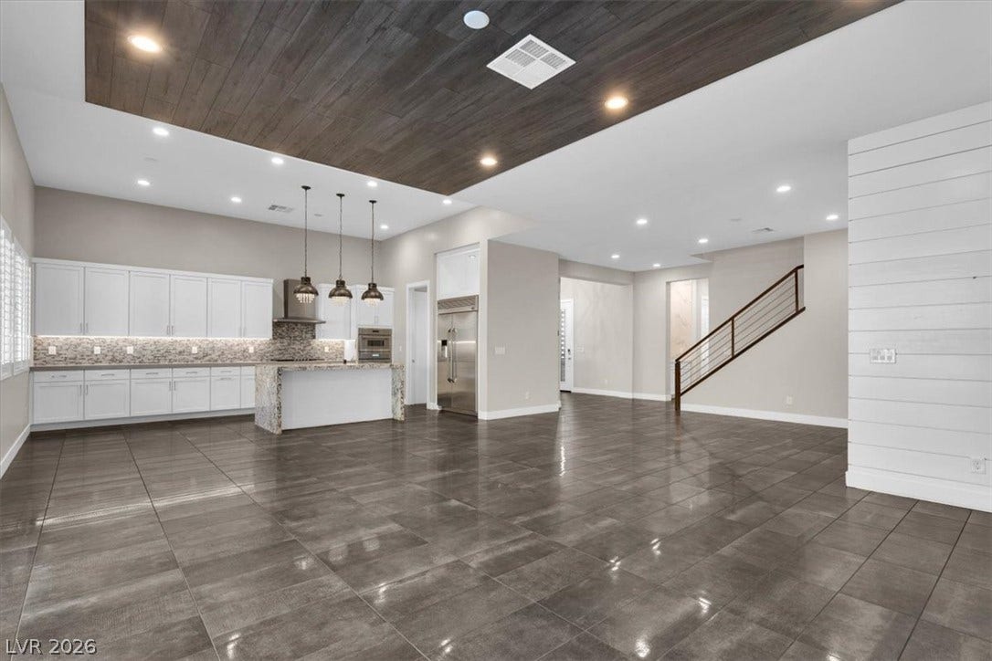 Open plan living room featuring wooden ceiling and recessed lighting