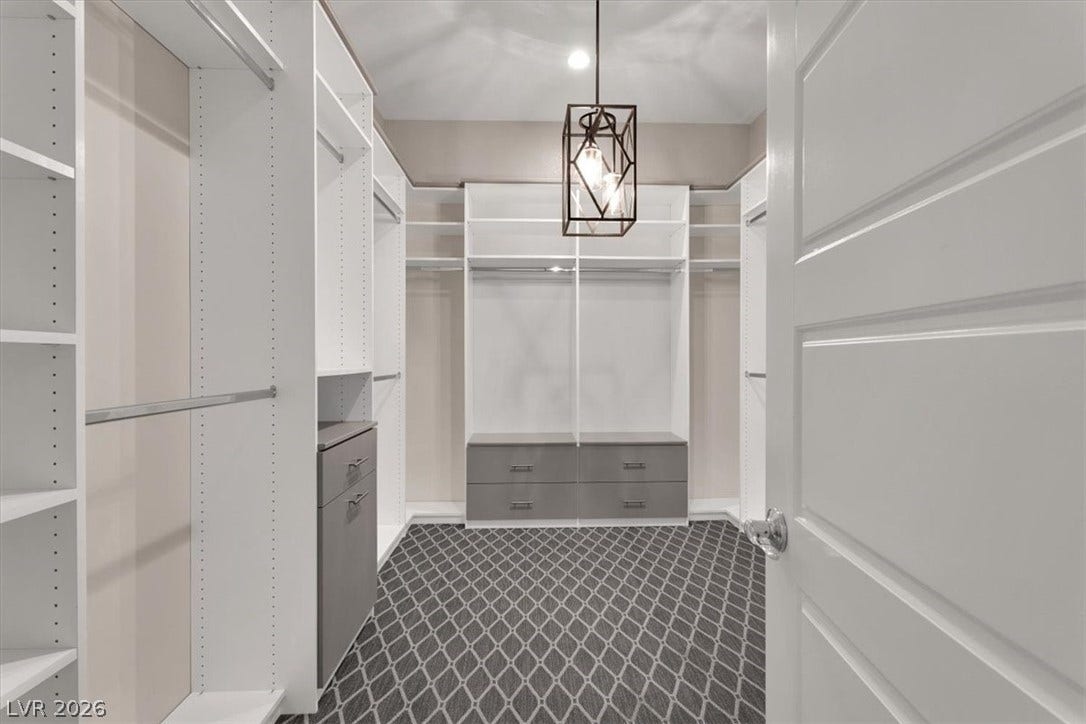Walk in closet with plush carpet and custom lighting