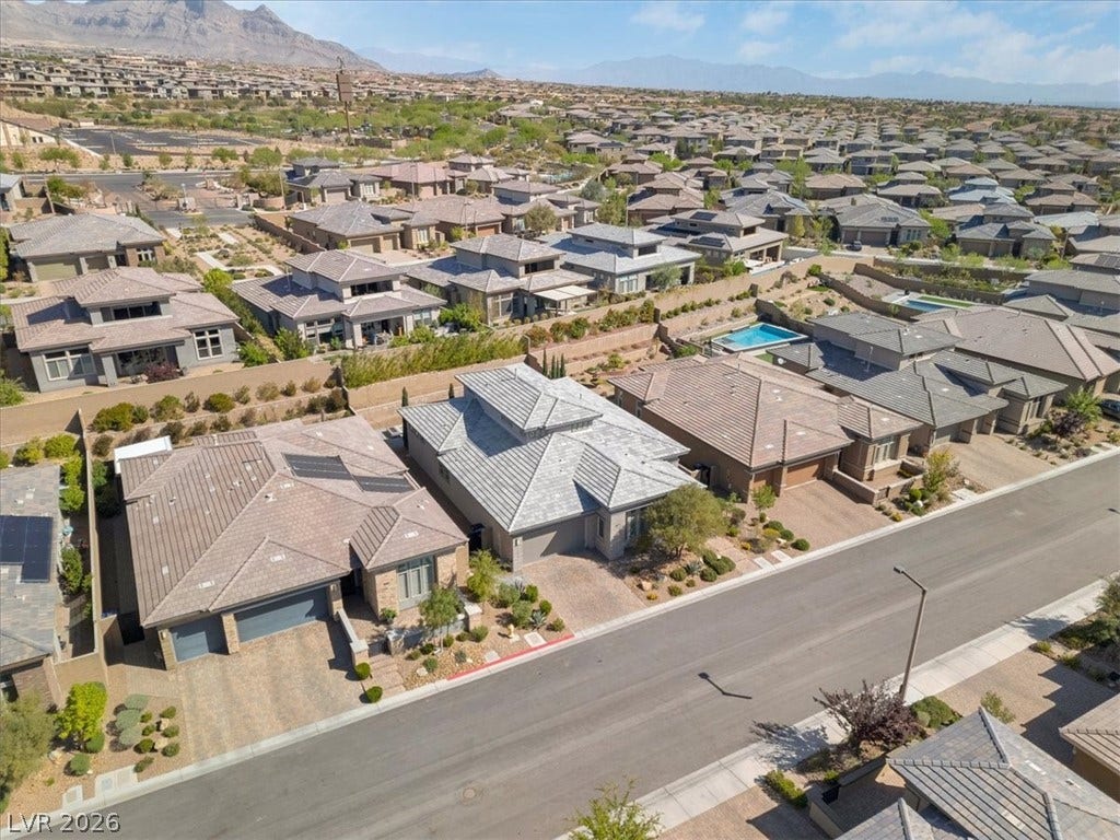 Aerial perspective of suburban area featuring a Red Rock mountain backdrop