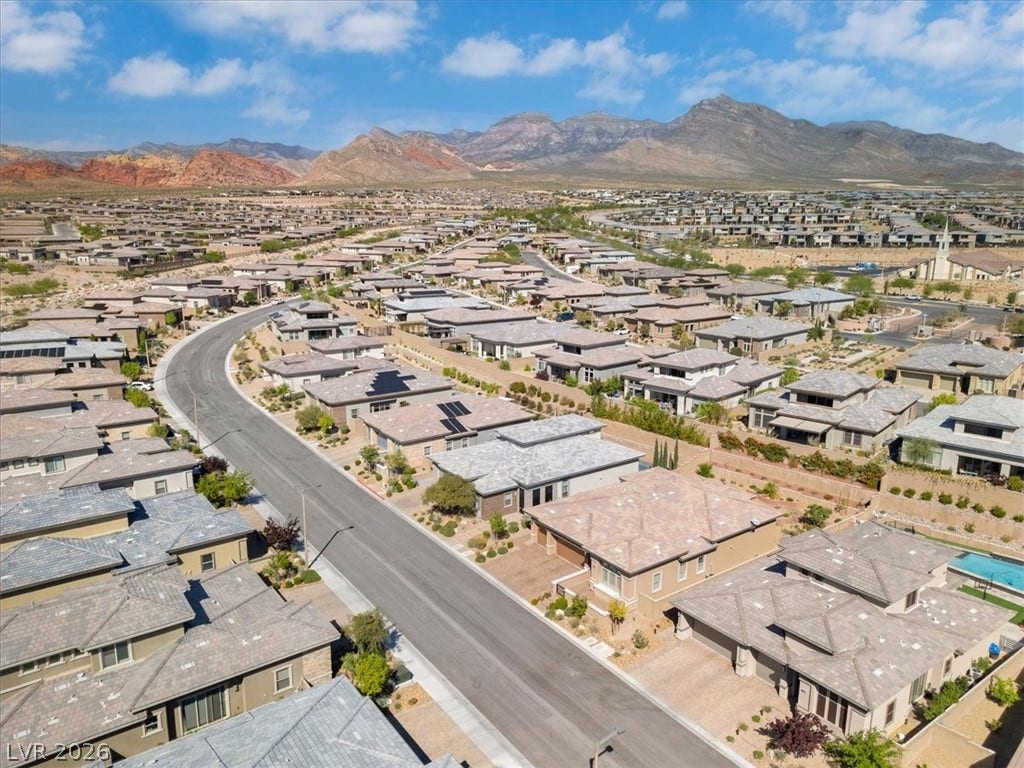 Aerial perspective of suburban area featuring a Red Rock mountain backdrop