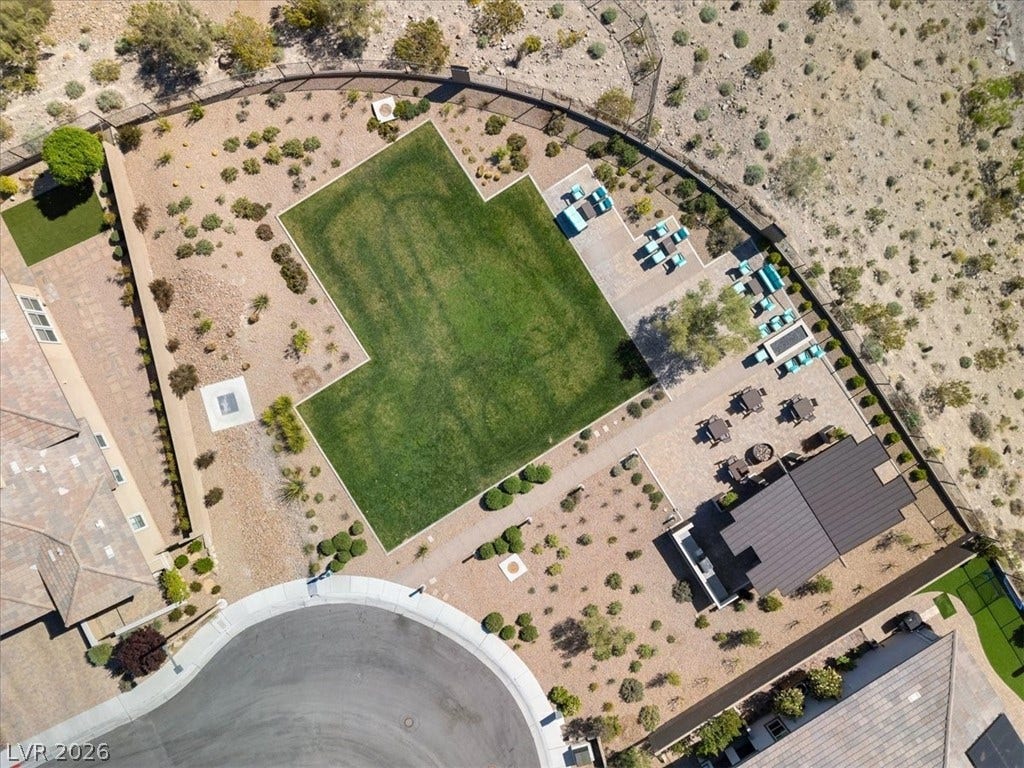 Aerial view of the community park featuring lush landscaping, covered areas and fire pit, with plenty of seating