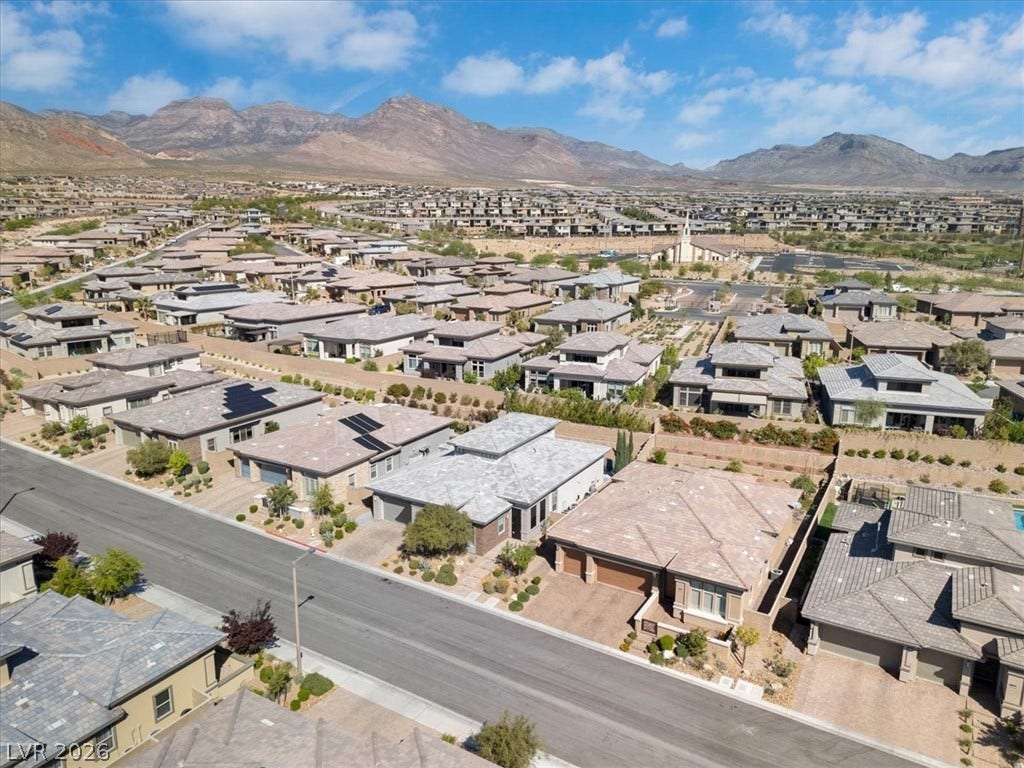 Aerial perspective of suburban area featuring a Red Rock mountain backdrop