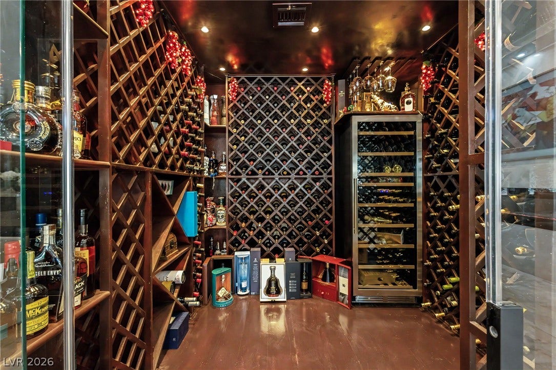 Custom floor-to-ceiling wooden racks and built-in refrigeration anchor this impressive climate-controlled wine cellar.