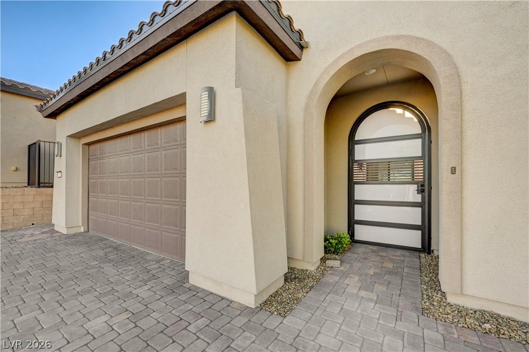 51 Thorn Creek Street, Henderson, NV 89011 Entrance to property featuring stucco siding, decorative driveway, an attached garage, and a tile roof