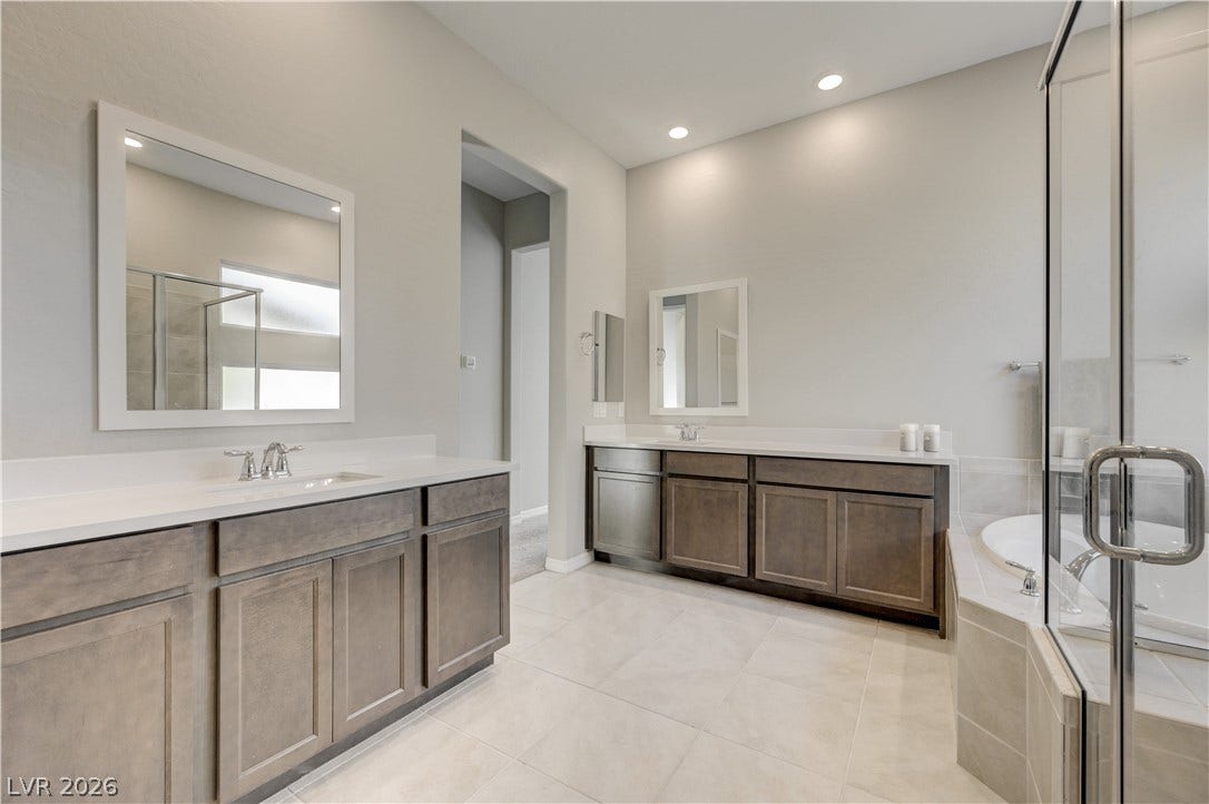 51 Thorn Creek Street, Henderson, NV 89011 Bathroom featuring a stall shower, two vanities, light tile patterned floors, a bath, and recessed lighting