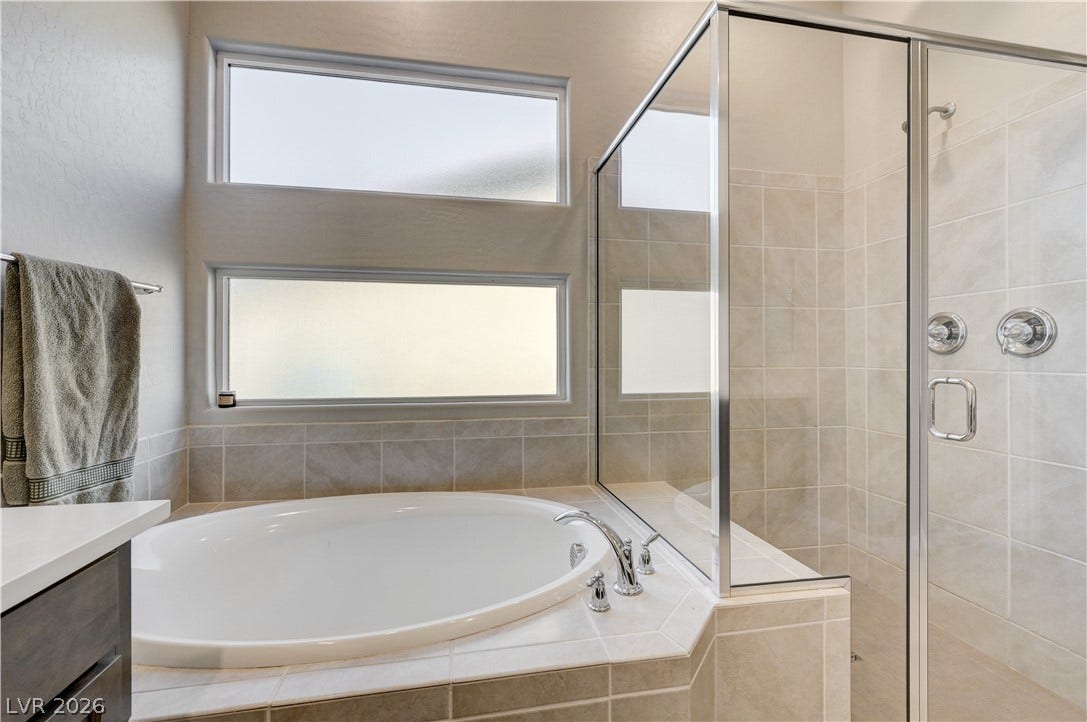 51 Thorn Creek Street, Henderson, NV 89011 Bathroom featuring a shower stall, healthy amount of natural light, a garden tub, and vanity