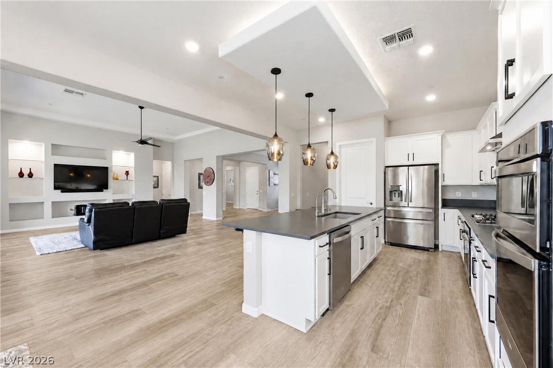 51 Thorn Creek Street, Henderson, NV 89011 Gleaming wood floors anchor an airy, open layout connecting the kitchen to the living space.
