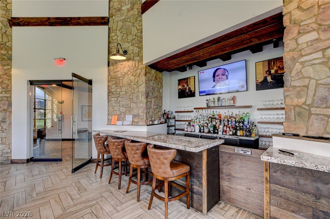 51 Thorn Creek Street, Henderson, NV 89011 Community bar area featuring a high ceiling and light stone countertops