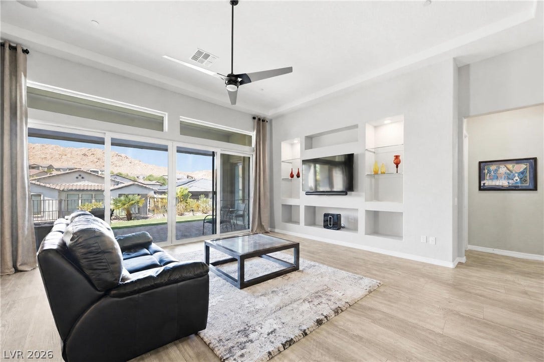 51 Thorn Creek Street, Henderson, NV 89011 A spacious living room features expansive sliding doors opening to mountain views.