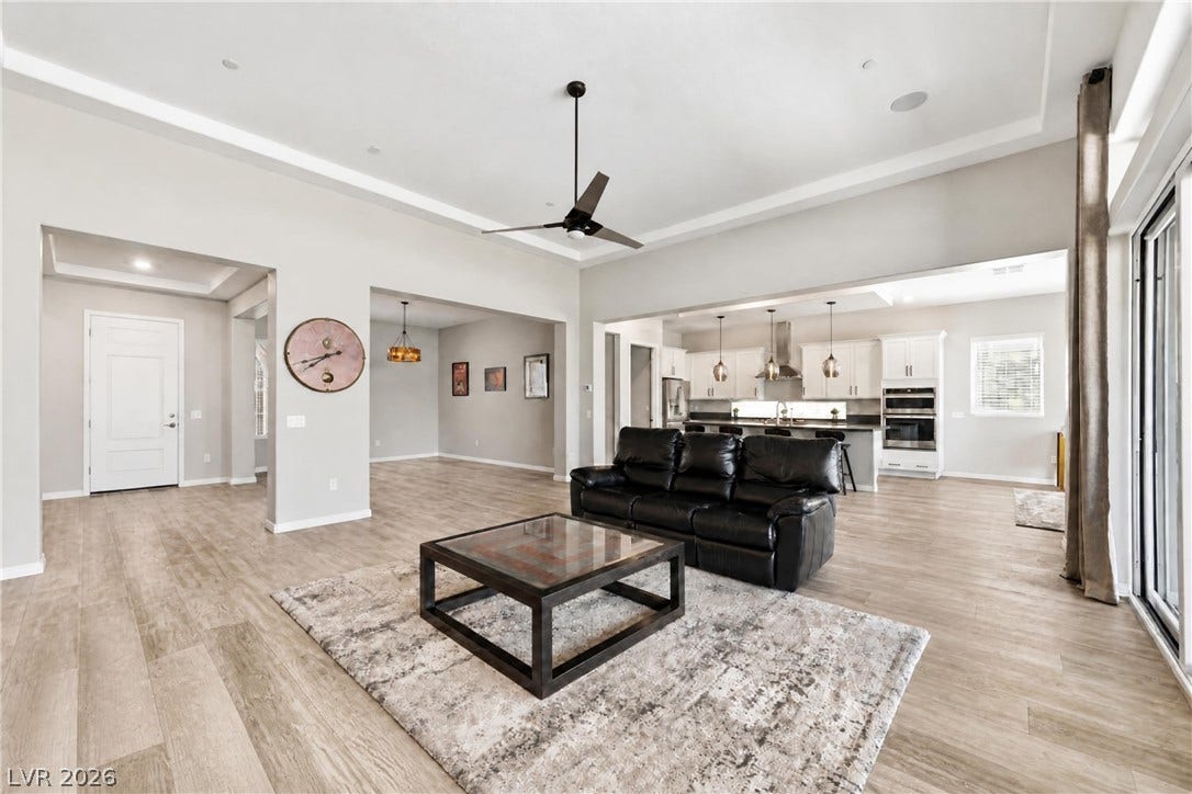 51 Thorn Creek Street, Henderson, NV 89011 An open floor plan connects the living area to a modern kitchen with high ceilings.