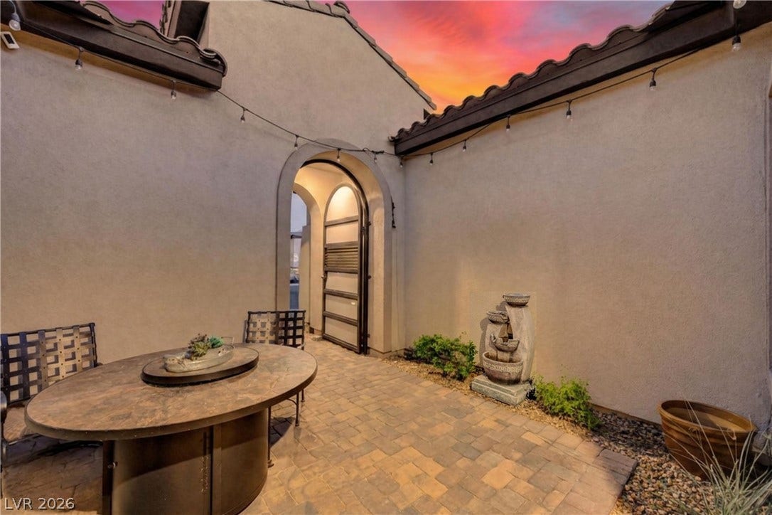 51 Thorn Creek Street, Henderson, NV 89011 An inviting stone-paved entry courtyard features stucco walls and an elegant arched wrought-iron gate.