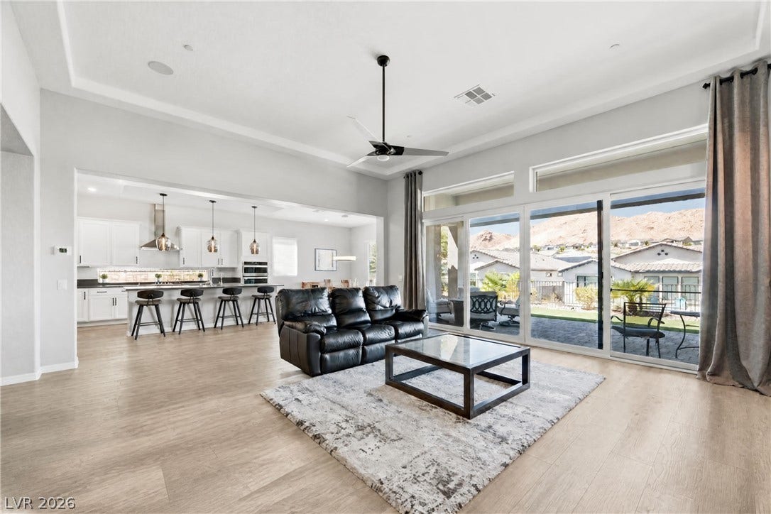 51 Thorn Creek Street, Henderson, NV 89011 Soaring ceilings and massive sliding glass doors frame mountain views in this airy open layout.