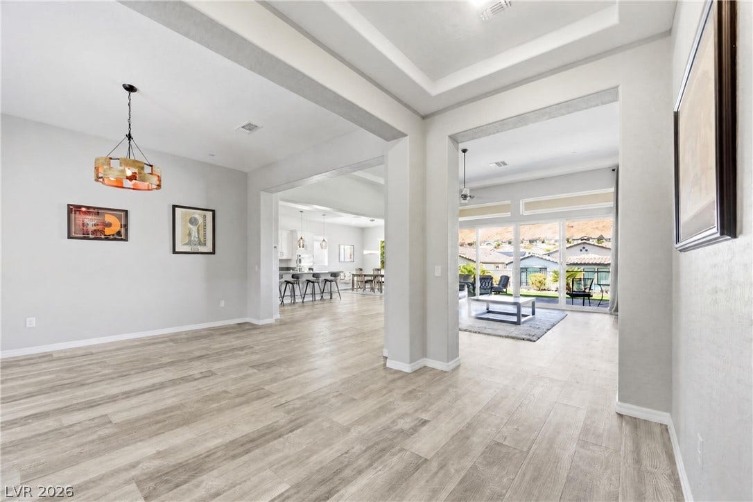 51 Thorn Creek Street, Henderson, NV 89011 Wide, columned openings connect these airy spaces over durable wood-look flooring.