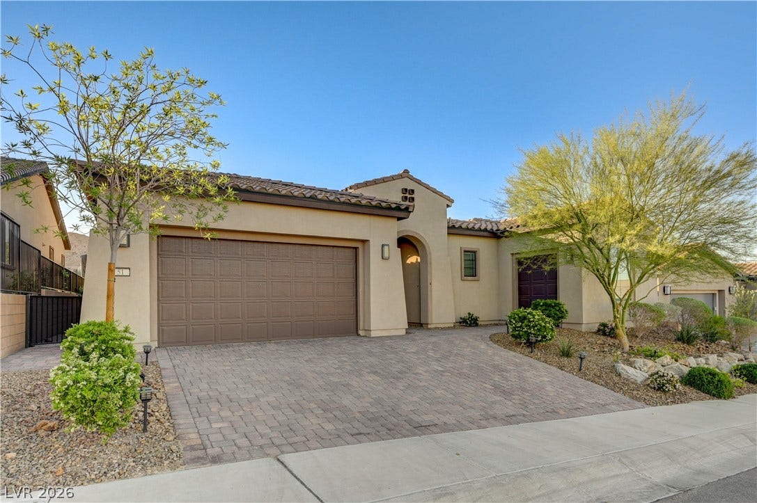 51 Thorn Creek Street, Henderson, NV 89011 Mediterranean / spanish-style house featuring decorative driveway, a garage, stucco siding, and a tile roof