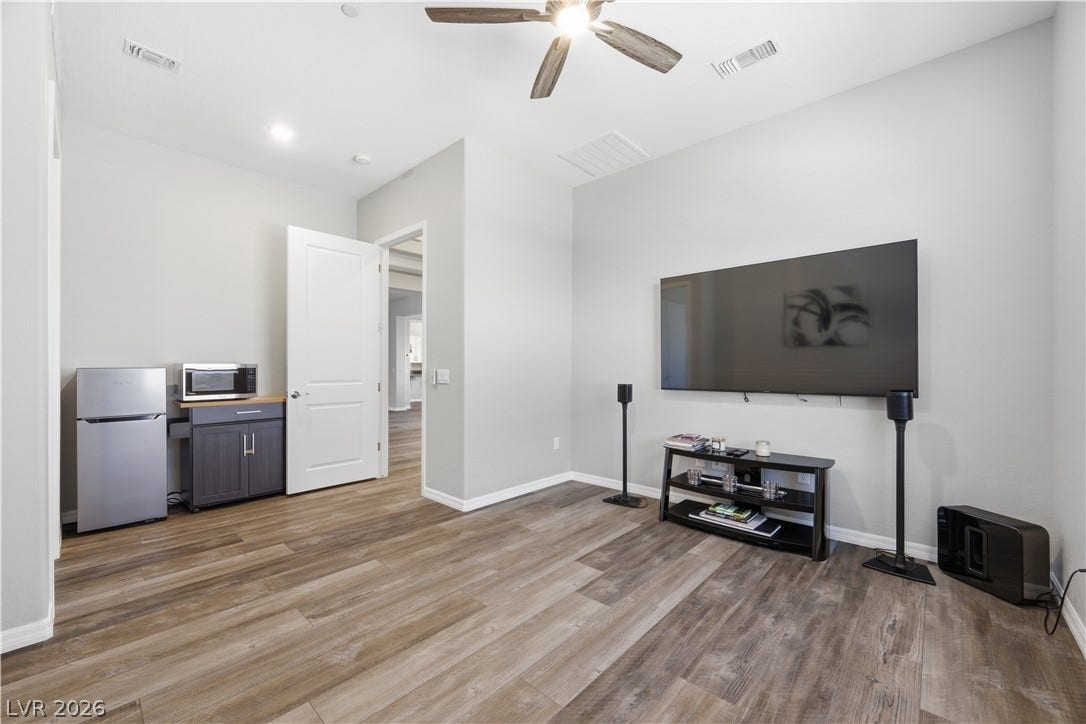 51 Thorn Creek Street, Henderson, NV 89011 Smooth wood-look flooring and stacked horizontal windows enrich this restful next-gen optional bedroom.