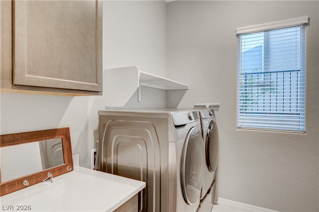 51 Thorn Creek Street, Henderson, NV 89011 Laundry area featuring washing machine and clothes dryer and cabinet space