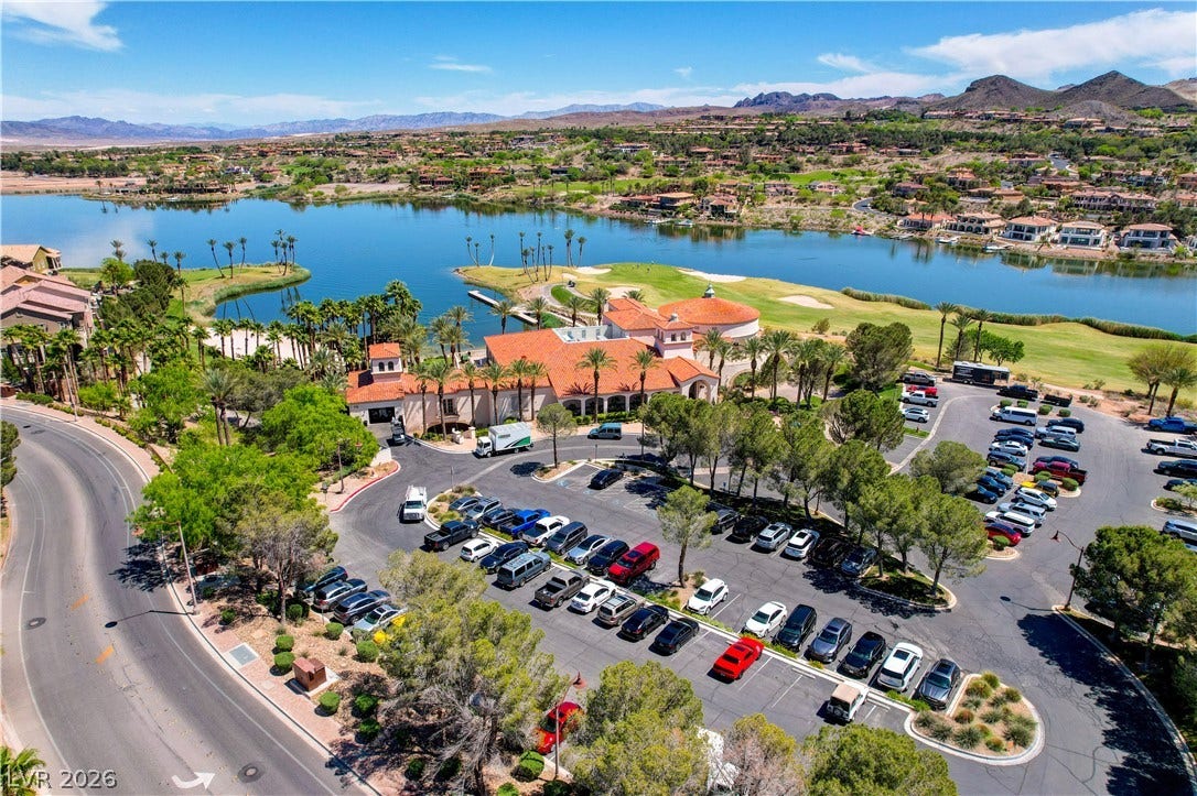 51 Thorn Creek Street, Henderson, NV 89011 Aerial perspective of suburban area with a golf course and a water and mountain view